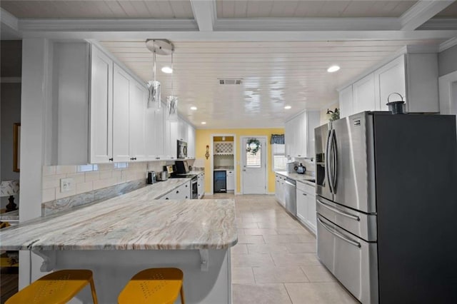 3120 Riviere Du Chien Loop W, Mobile, AL 36693 - kitchen featuring appliances with stainless steel finishes, a peninsula, white cabinetry, backsplash, and recessed lighting