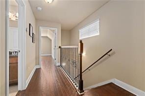 267 Galaxy St, Fairhope, AL 36532 - hallway with an upstairs landing, dark wood-style flooring, and baseboards