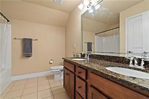 267 Galaxy St, Fairhope, AL 36532 - full bathroom featuring vaulted ceiling, double vanity, baseboards, toilet, and tile patterned flooring