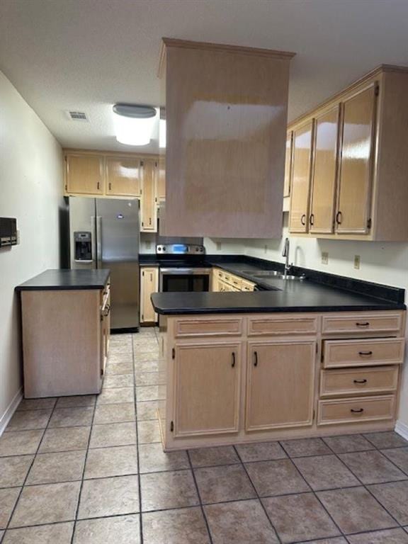 kitchen with light brown cabinetry, sink, light tile patterned floors, and appliances with stainless steel finishes