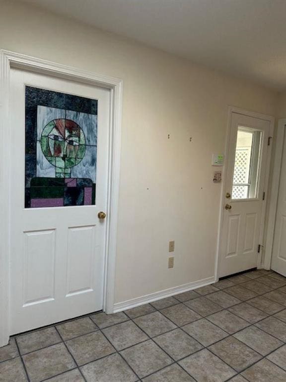 entryway with light tile patterned floors