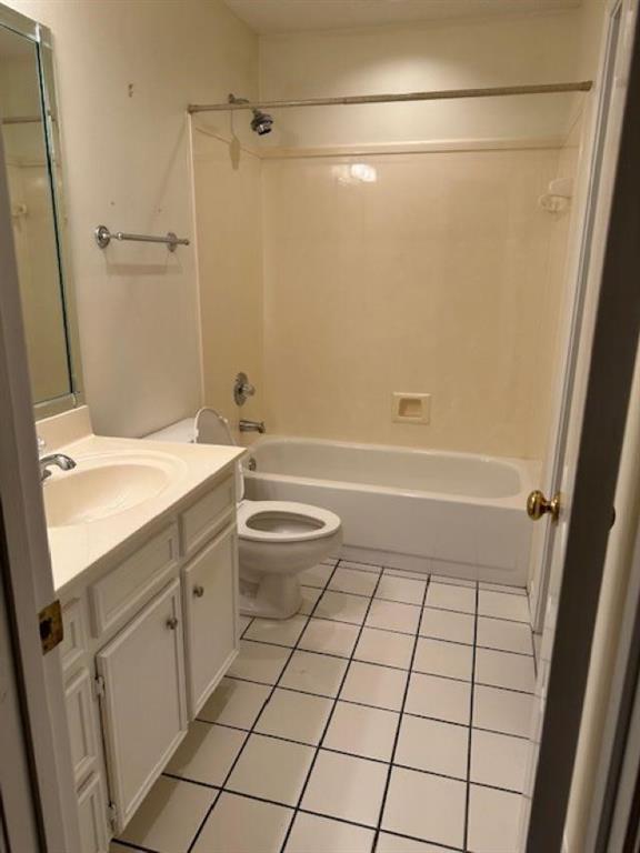 full bathroom with vanity, tile patterned floors, toilet, and shower / bath combination