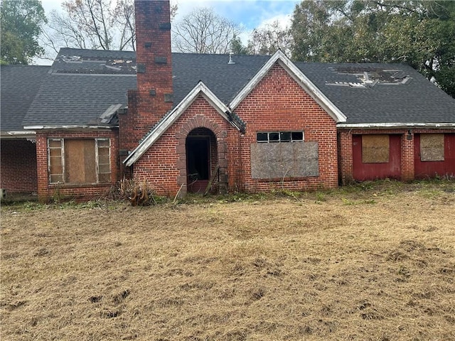 rear view of house featuring a lawn