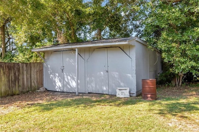 view of outbuilding featuring a lawn