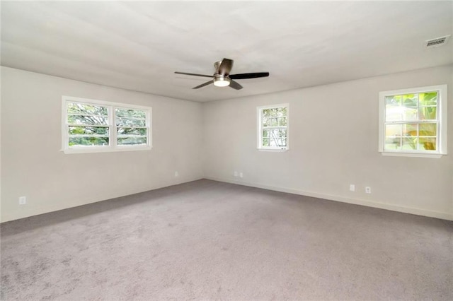 carpeted empty room featuring ceiling fan