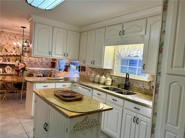 kitchen with dishwasher, decorative light fixtures, a kitchen island, and sink