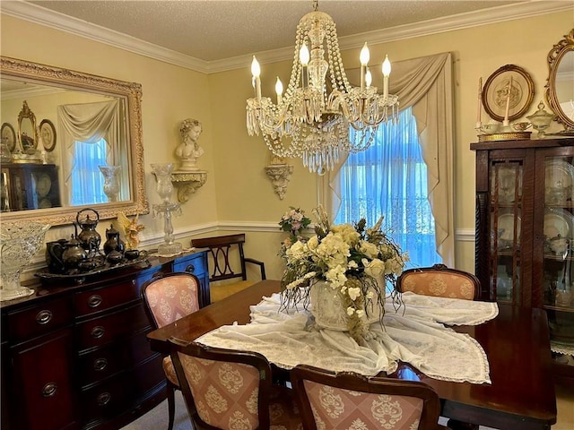 dining space featuring crown molding, a textured ceiling, and an inviting chandelier