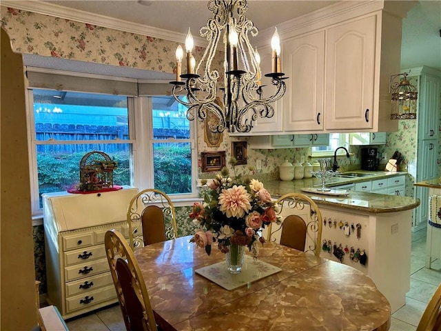 dining room featuring a notable chandelier, crown molding, light tile patterned floors, and sink