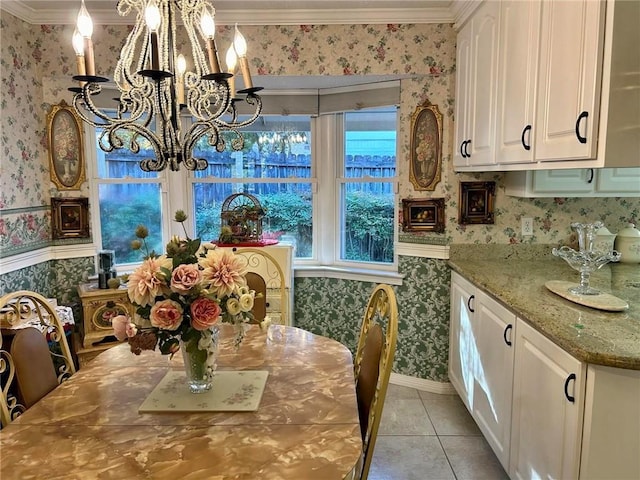 tiled dining space with crown molding and a notable chandelier