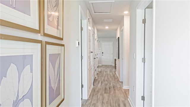 hallway with light hardwood / wood-style floors