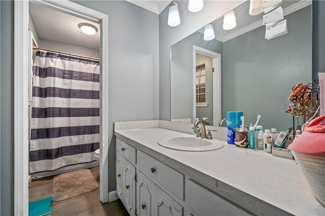 bathroom featuring crown molding, vanity, and toilet