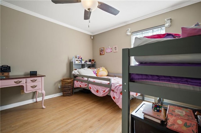 bedroom featuring ceiling fan, crown molding, and light hardwood / wood-style flooring