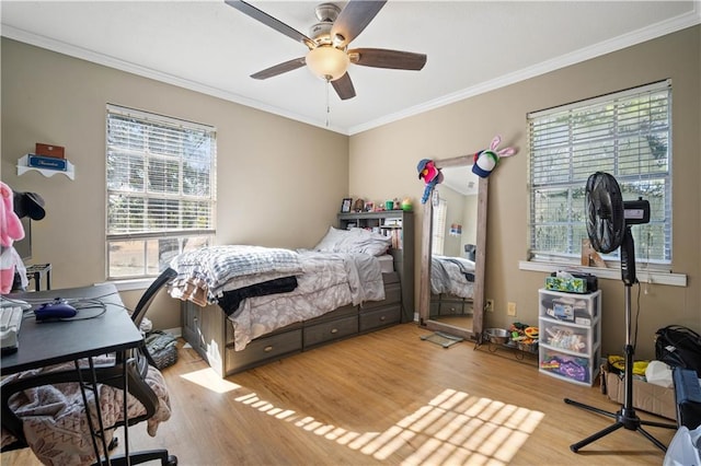 bedroom with light hardwood / wood-style flooring, ceiling fan, and crown molding