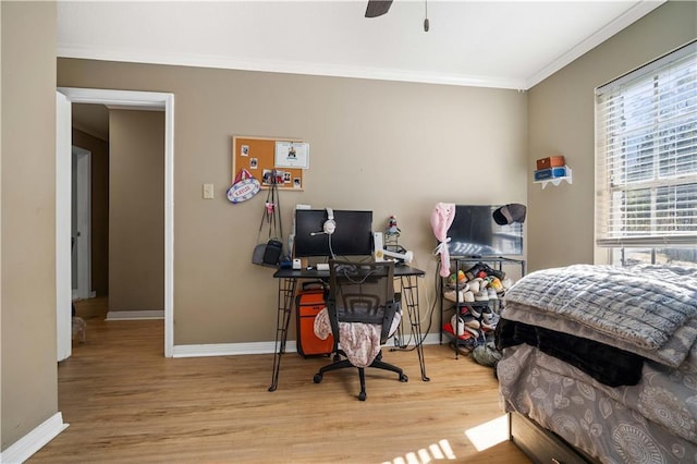 bedroom with hardwood / wood-style flooring, ceiling fan, and ornamental molding