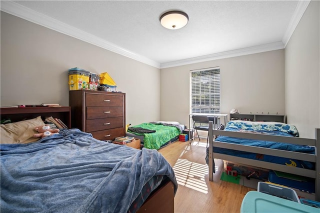 bedroom featuring light hardwood / wood-style floors and ornamental molding