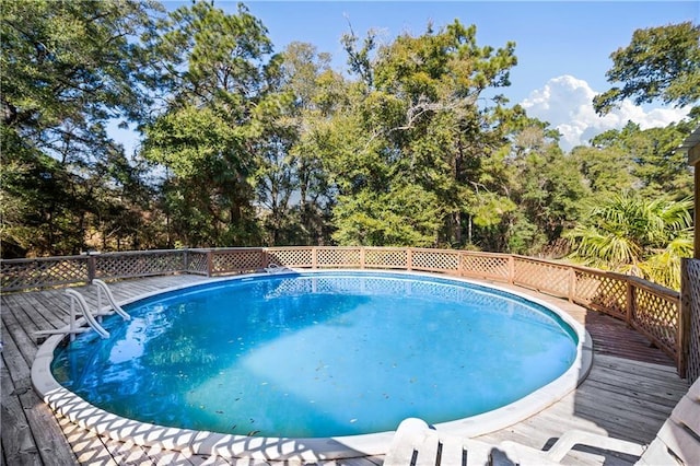 view of swimming pool with a wooden deck