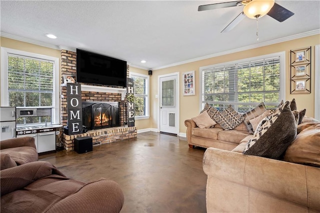 living room with a fireplace, a wealth of natural light, crown molding, and ceiling fan