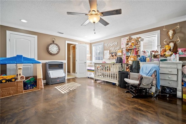 bedroom with ceiling fan, ornamental molding, a textured ceiling, and a nursery area