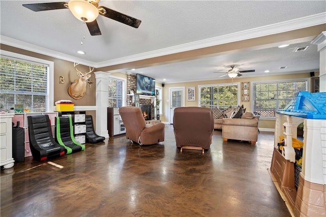 interior space with a fireplace, a textured ceiling, a wealth of natural light, and ornamental molding