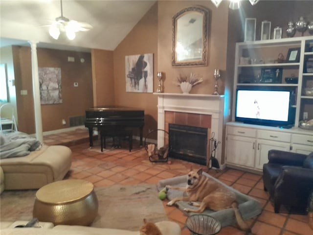 tiled living room featuring lofted ceiling, a fireplace, ceiling fan, and plenty of natural light