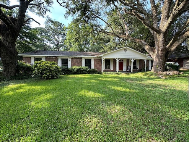 ranch-style home with covered porch and a front lawn