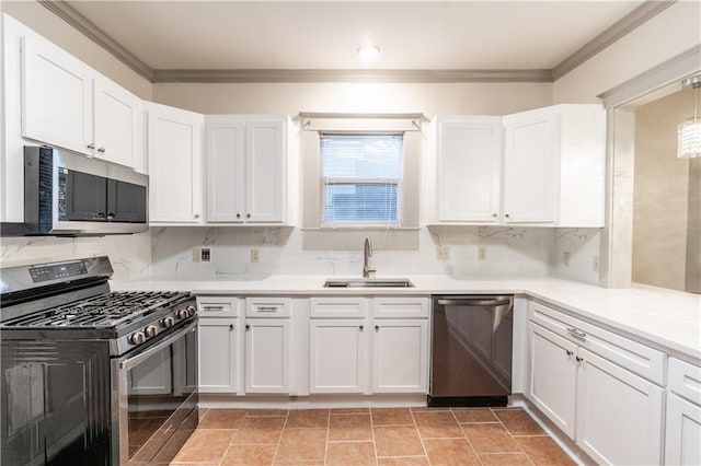 kitchen with backsplash, crown molding, sink, appliances with stainless steel finishes, and white cabinetry