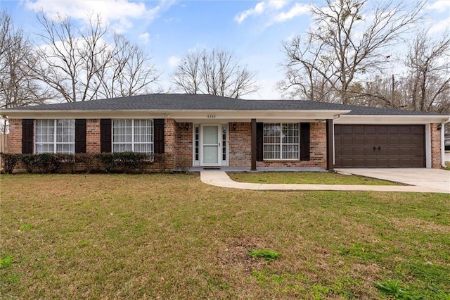 single story home featuring a garage, a front yard, brick siding, and driveway