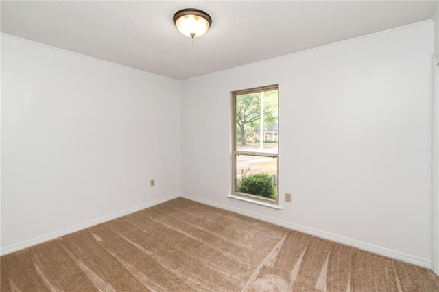empty room featuring carpet floors and baseboards