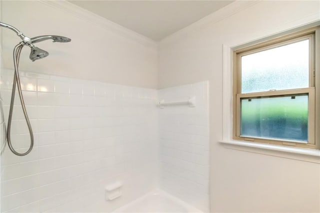 full bathroom featuring a tile shower and ornamental molding