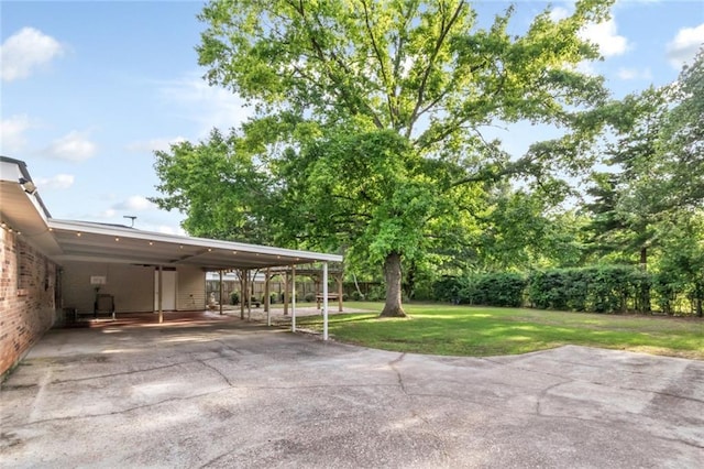 view of patio / terrace with a carport and driveway