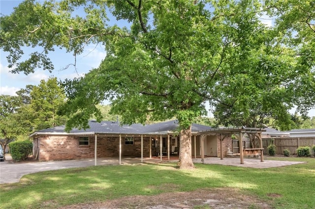 back of property with a patio, brick siding, and a pergola