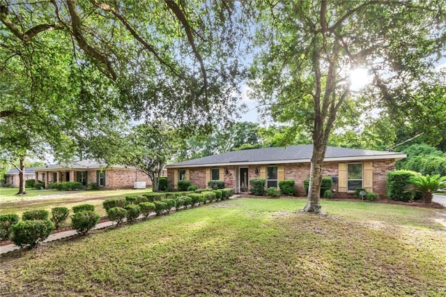 ranch-style home with a front lawn and brick siding