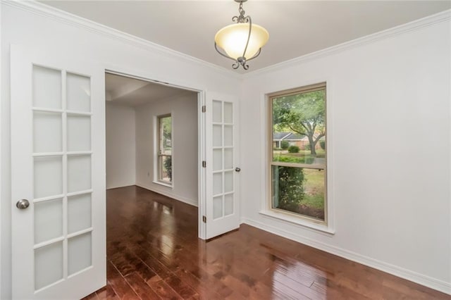 unfurnished dining area featuring wood finished floors, ornamental molding, and baseboards