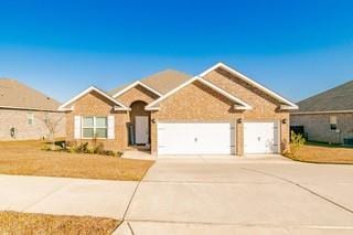 ranch-style house with an attached garage and concrete driveway