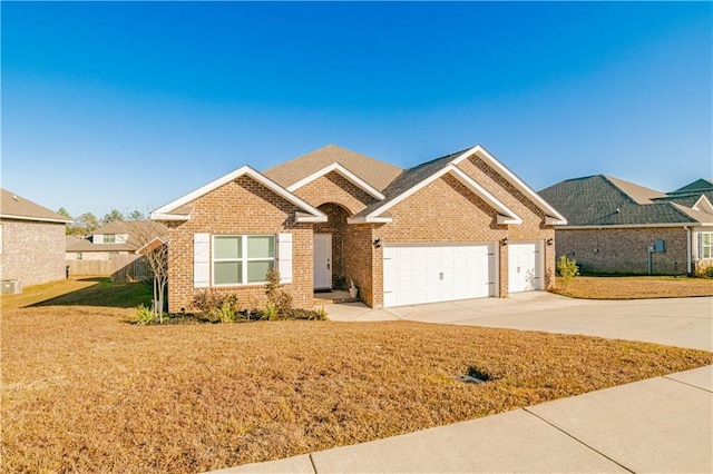 ranch-style house featuring brick siding, an attached garage, driveway, and a front yard