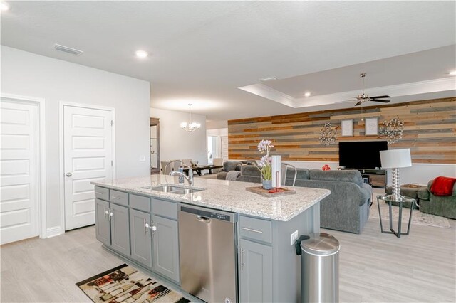 kitchen with visible vents, light wood-type flooring, gray cabinets, a sink, and dishwasher
