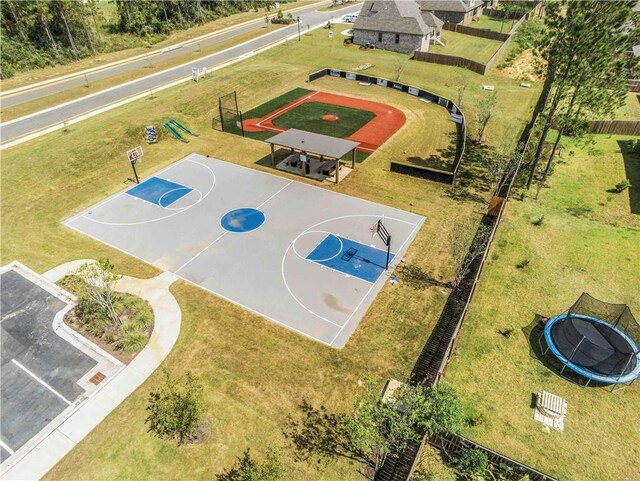 view of sport court with fence, community basketball court, and a yard