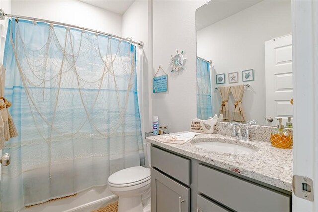 bathroom with vanity, toilet, and shower / tub combo with curtain