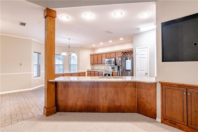 kitchen featuring kitchen peninsula, light stone countertops, sink, and appliances with stainless steel finishes