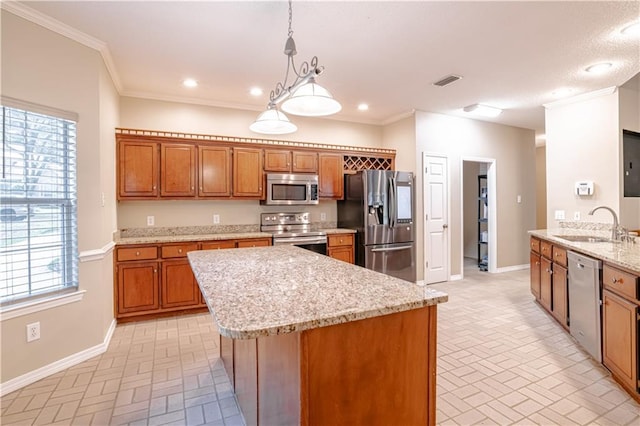 kitchen featuring sink, hanging light fixtures, ornamental molding, kitchen peninsula, and stainless steel appliances