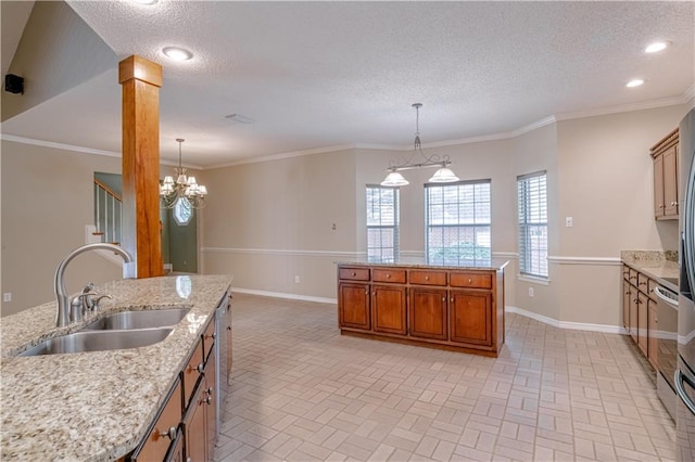 kitchen featuring crown molding, sink, hanging light fixtures, and decorative columns