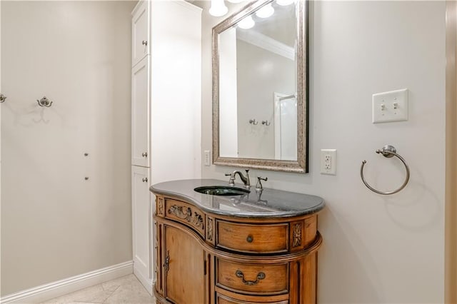 bathroom with tile patterned flooring, vanity, and crown molding