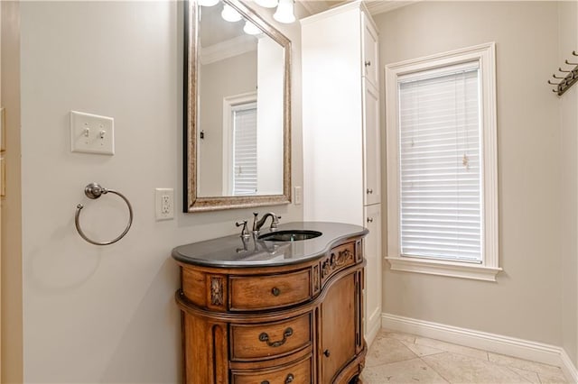 bathroom featuring tile patterned flooring, vanity, and crown molding