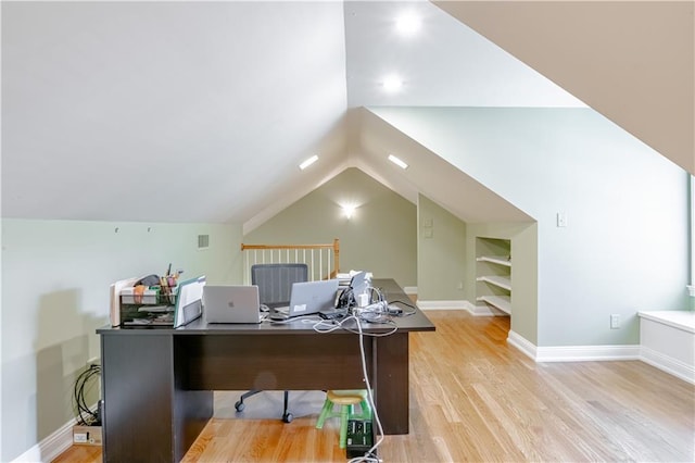 office space featuring light hardwood / wood-style floors and vaulted ceiling