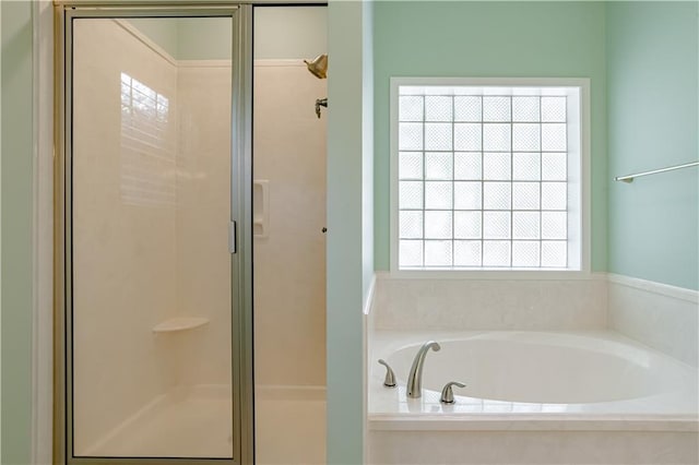 bathroom featuring independent shower and bath