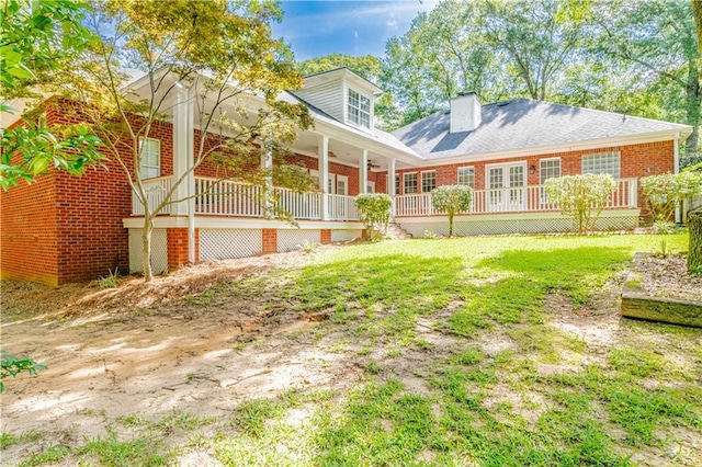 back of house featuring a yard