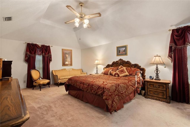 carpeted bedroom with visible vents, ceiling fan, and lofted ceiling