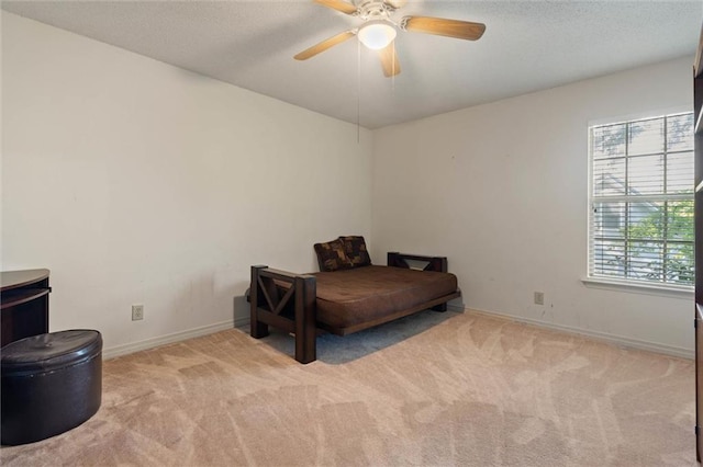 carpeted bedroom featuring baseboards, ceiling fan, and a textured ceiling