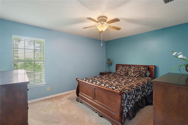 bedroom with a ceiling fan, baseboards, multiple windows, and light carpet