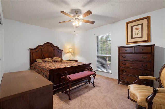 bedroom with light colored carpet, a textured ceiling, and ceiling fan